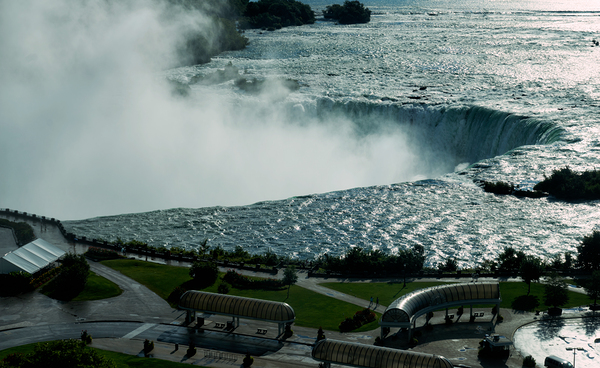 Niagara Falls with powerful water mist and surrounding park. Print