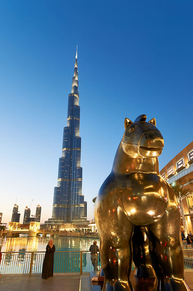 Burj Khalifa and golden horse statue at dusk in Dubai Print