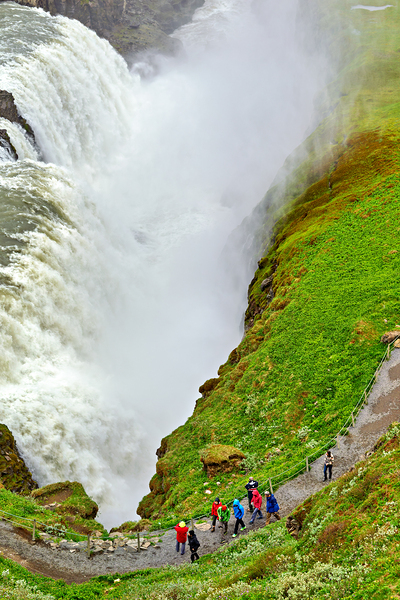 Visitors explore Gullfoss waterfall in Iceland on a cloudy day by Marco Brivio