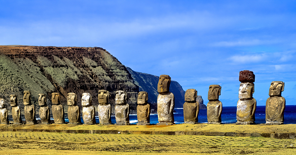 Easter Island Moai statues against ocean and cliffs. by Marco Brivio