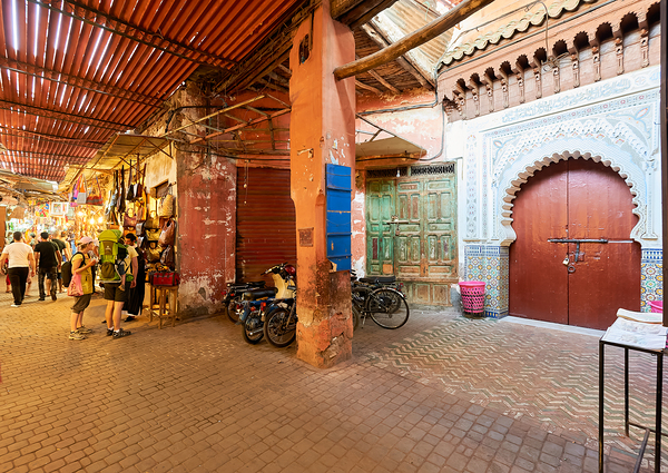 Exploring the souk in Marrakesh Morocco during daytime hours Print