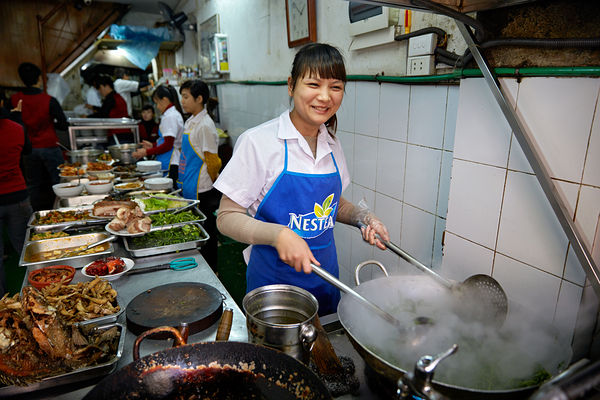 Chefs cook in busy kitchen in Hanoi during lunchtime rush Digital Download