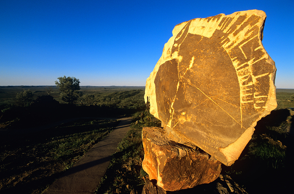 Carved stone monument in the Australian outback at sunset. Print