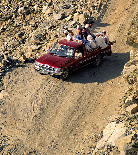 Travelers on gravel road near Shandur Pass in Pakistan Print