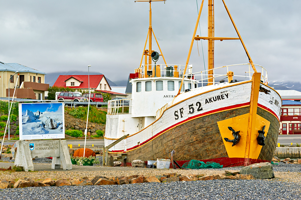 Visit to Hofn harbor in Iceland with fishing boat and sign by Marco Brivio