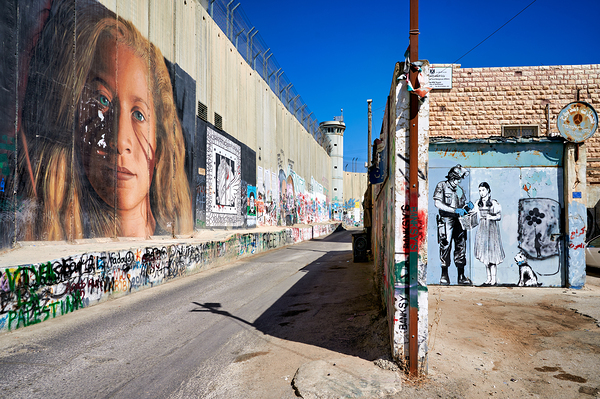 West Bank separation wall in Bethlehem shows murals and artwork Print