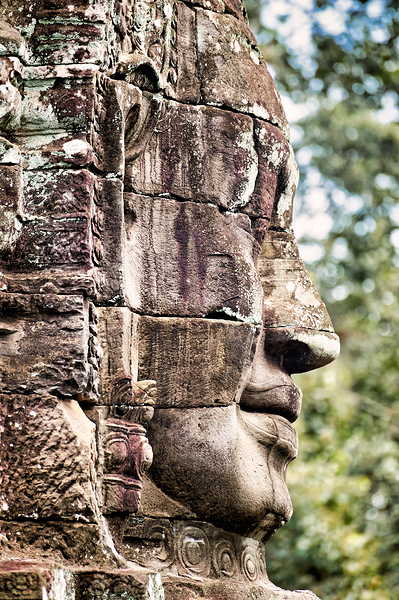 Weathered stone face carving from an ancient temple. Print
