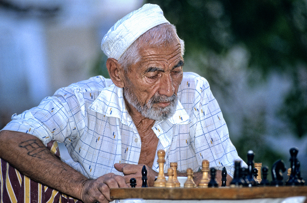 Elderly man plays chess in Bukhara Uzbekistan Print