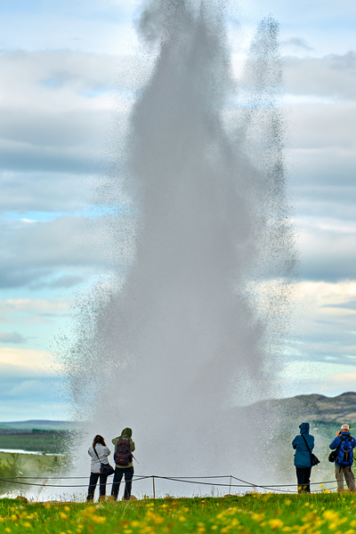 Strokkur geyser erupts in Iceland with visitors nearby by Marco Brivio