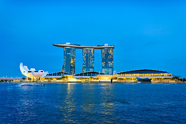 City skyline at sunset over Marina Bay with reflections on water Print