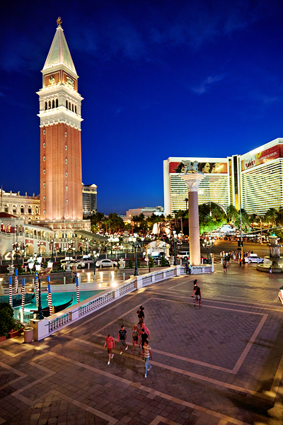 Venetian Hotel at sunset with visitors in Las Vegas by Marco Brivio