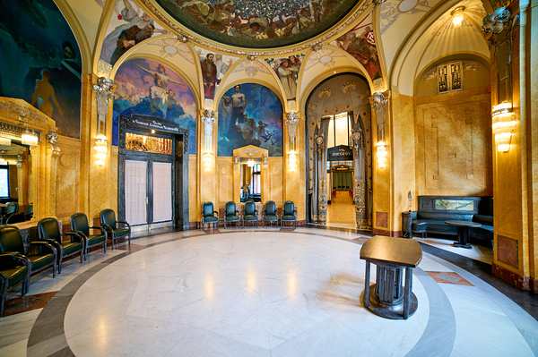 Ornate historic hall with murals arches and elegant seating. Print