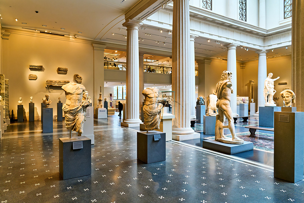 Visitors explore Greek and Roman galleries at the Met Print