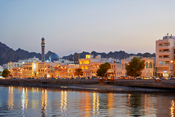 Sunset view of waterfront in Muscat Oman with city lights Print