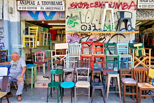 Flea market in Monastiraki shows colorful chairs for sale by Marco Brivio