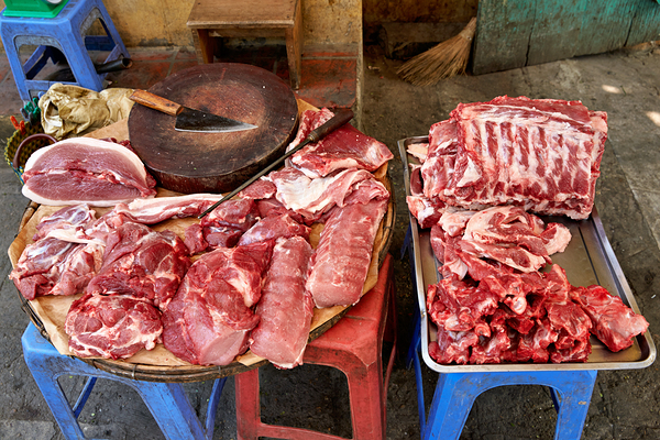 Fresh meat sold in Hanoi market during daytime Print
