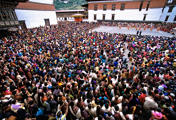 Bhutanese festival: crowd watches traditional dance in monastery Print