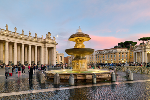 Saint Peters Square at dusk with Berninis fountain and people by Marco Brivio