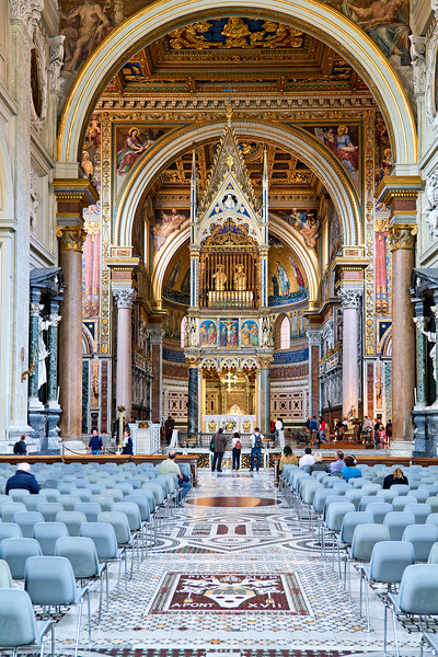 Visitors explore the Archbasilica Cathedral in Rome Italy by Marco Brivio
