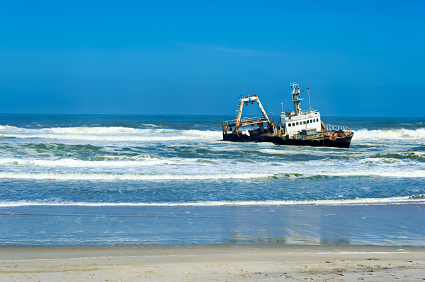 Shipwreck on the Skeleton Coast of Namibia under clear blue sky Print