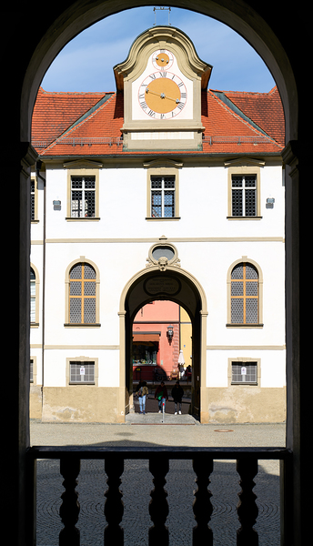 Visitors walk through the archway of Benediktinerkloster St by Marco Brivio