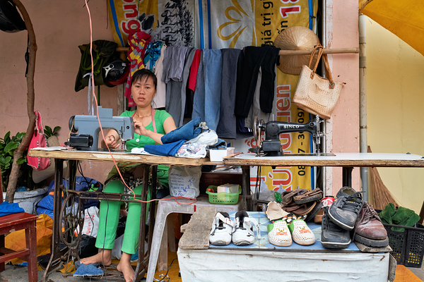 Sewing clothes at a market stall in Phu Quoc Vietnam Print