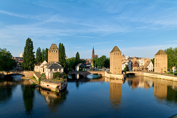 Covered bridges in Strasbourg by the river on a clear day Print