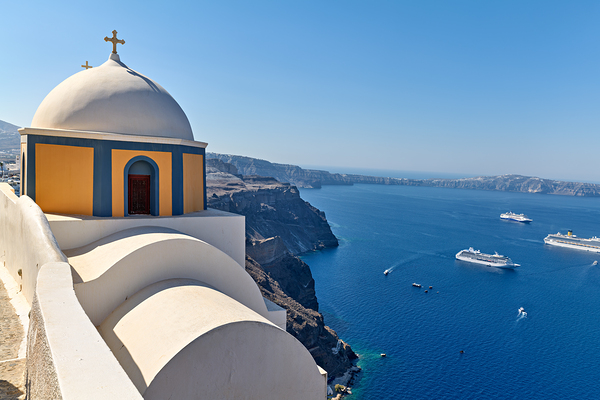 Santorinis iconic church and caldera with ships. by Marco Brivio