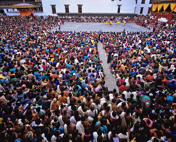 Large crowd watches traditional dance performance at outdoor fes Print