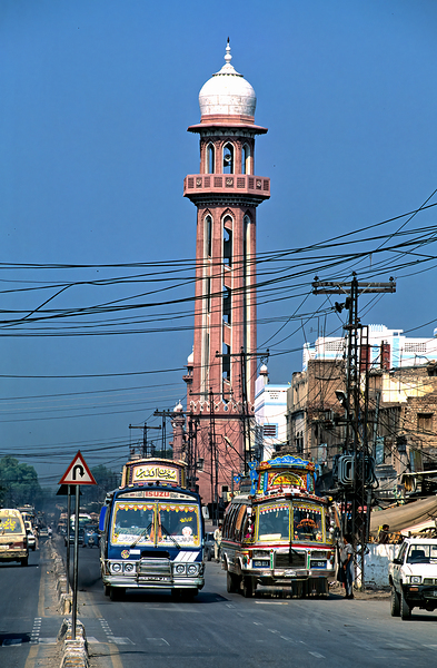 Busy street scene with tall tower in Peshawar Pakistan Print