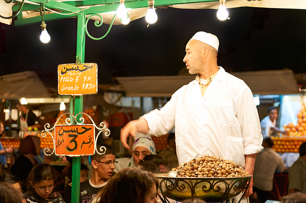 Snail dinner served at street vendors in Marrakech night market Print