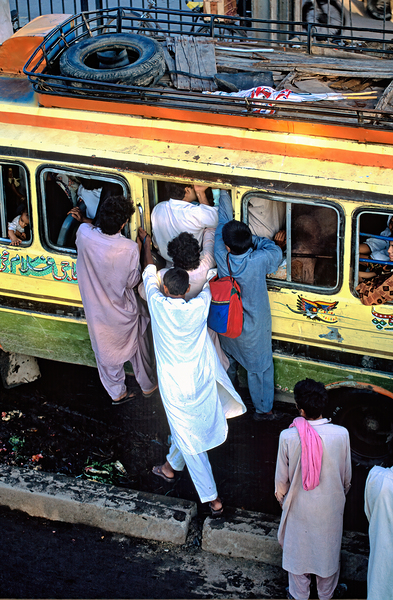 People boarding a bus in Lahore during busy hours Print
