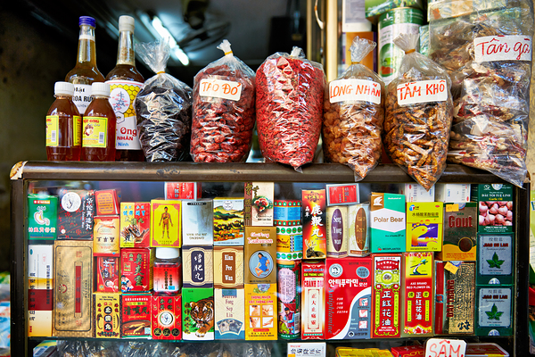 Market scene in Hanoi with spices and snacks on display Print