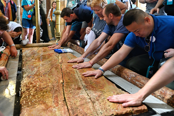 Visitors touch the stone of unction in the Holy Sepulchre Print