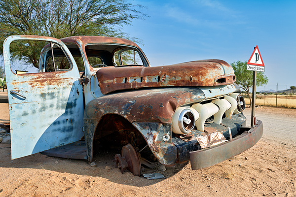 Classic car wreck in Namibias desert environment Print