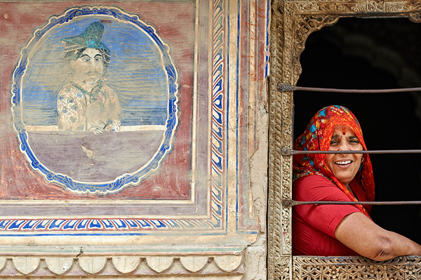 Woman smiles while looking out of a window in Mandawa Rajasthan Print