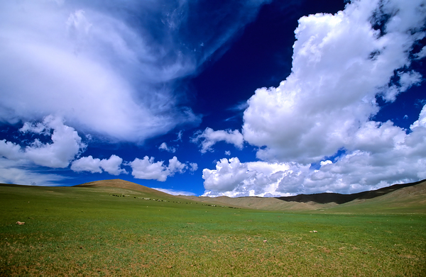 Vast sky over empty landscape in Mongolia during daytime by Marco Brivio