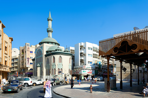 Middle Eastern street scene with mosque and market in Dubai UAE Print