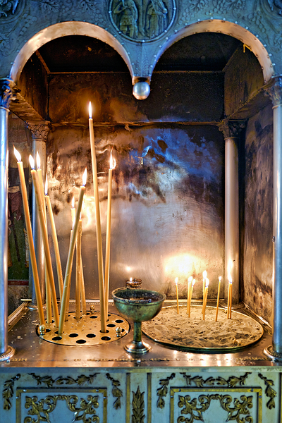 Votive candles lit inside Ekklisia Panagia Grigorousa in Athens  by Marco Brivio