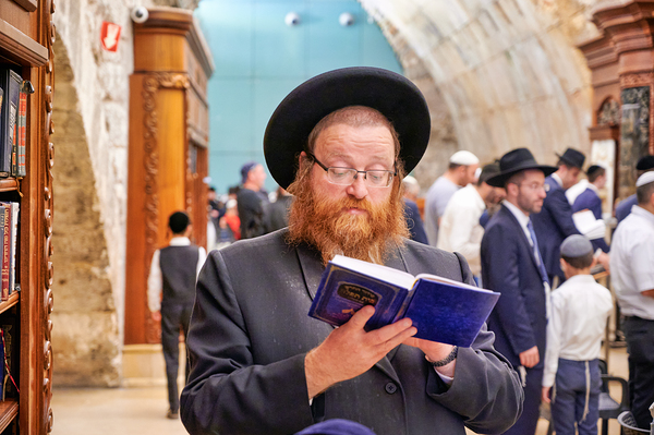 Orthodox Jews pray at the Western Wall in Jerusalem by Marco Brivio