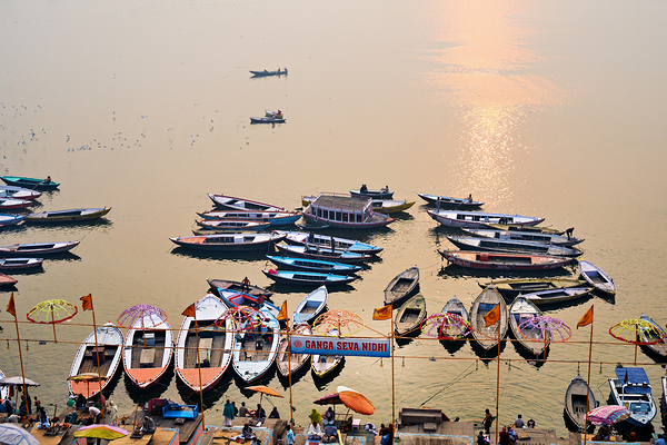 Sunrise at Ganges River in Varanasi with boats and activities Print