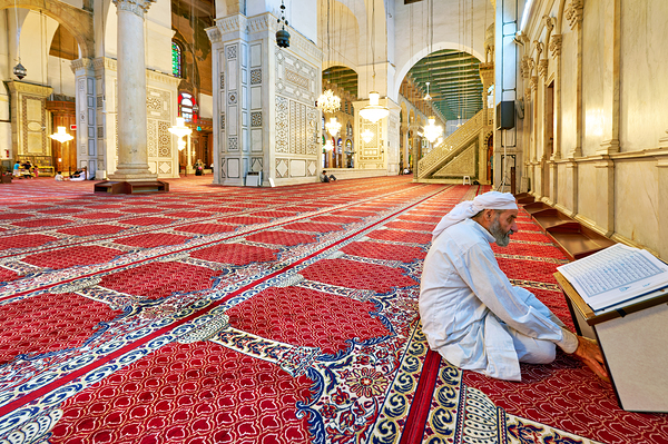 Visitor reading Quran in Umayyad Mosque in Damascus Print