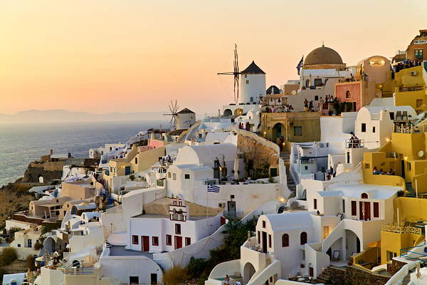 Whitewashed Santorini village and windmills at sunset over the s Print