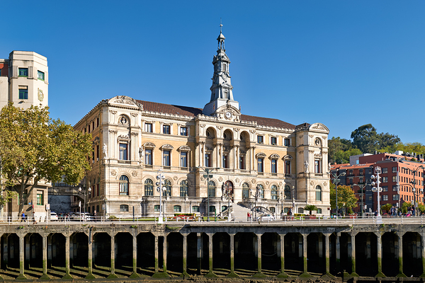 Building stands in Bilbao Spain next to water and trees Print