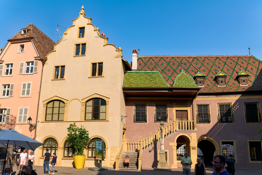 Visitors gather at Koifhus old custom house in Colmar Alsace  Print