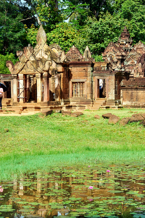 Ancient Cambodian temple reflected in a pond with water lilies.  Print