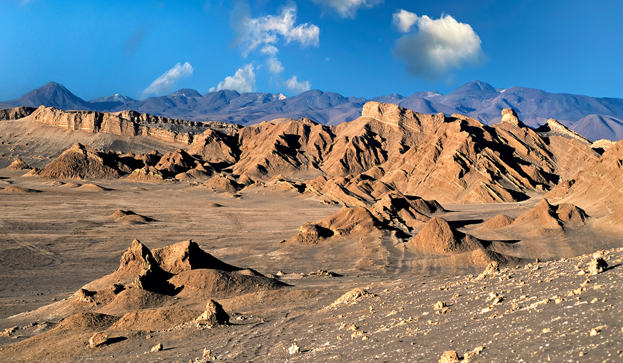 Rugged desert mountains under a clear blue sky with clouds.  Print