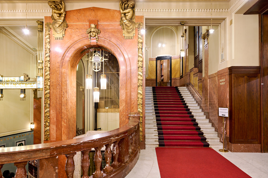 Elegant interior with red carpeted staircase and ornate gold det  Print
