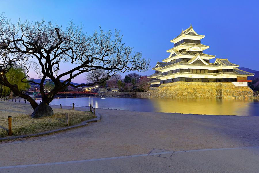 Matsumoto Castle stands by a river at sunset in Japan  Print