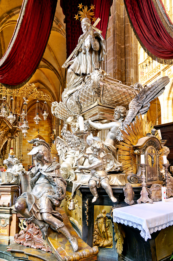 Ornate silver religious monument inside a grand cathedral.  Print